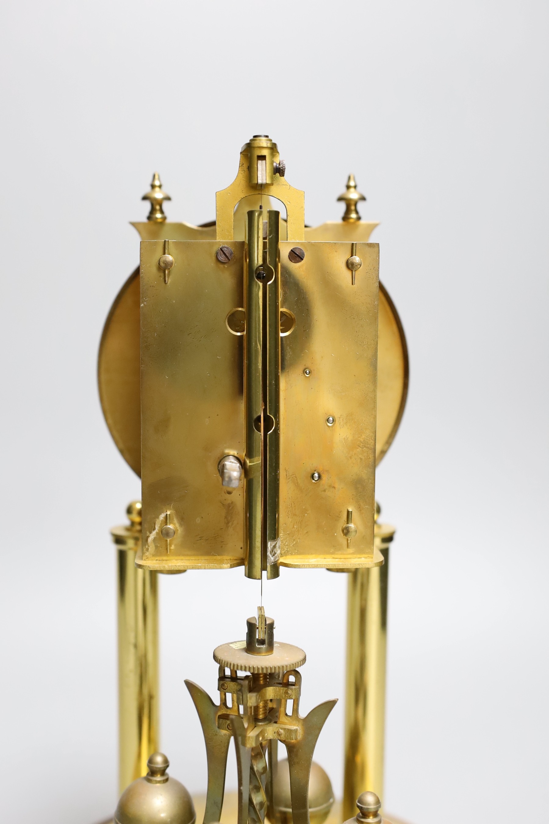 A German 400 day brass mantel timepiece, under a glass dome, 30cm total height
